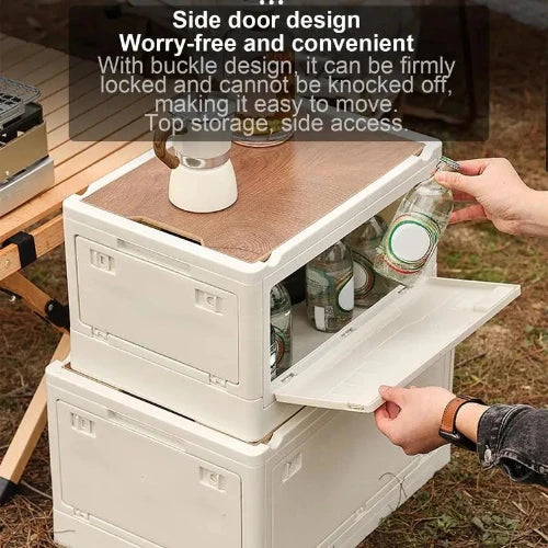 A white foldable camping storage box with a side door open.  A person is reaching into the box to retrieve a jar. The text on the image reads: "Side door design. Worry-free and convenient. With buckle design, it can be firmly locked and cannot be knocked off, making it easy to move. Top storage, side access."