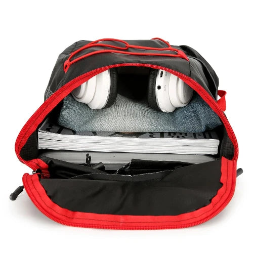 On white background. This picture shows the bag filled with several notebooks, a par of jeans, and headphones to show size and capacity.