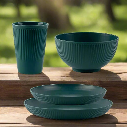 A dark green wheat straw dinnerware set. The set includes one large plate, one small plate, one bowl and one cup.