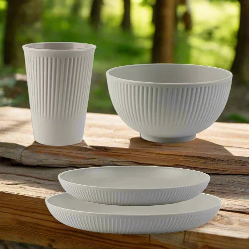 A light grey wheat straw dinnerware set. The set includes one large plate, one small plate, one bowl and one cup.