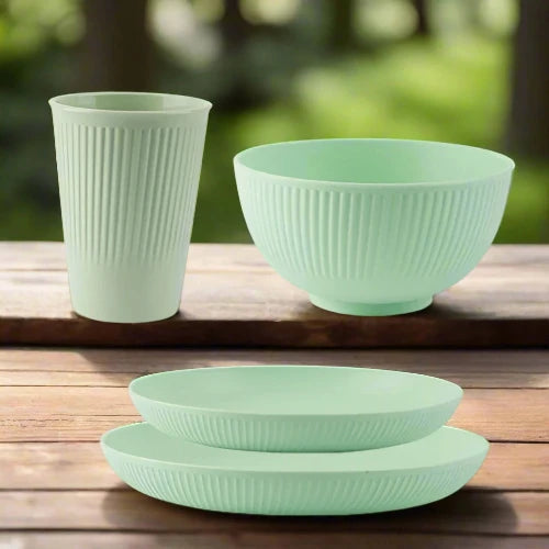 A light green wheat straw dinnerware set. The set includes one large plate, one small plate, one bowl and one cup.