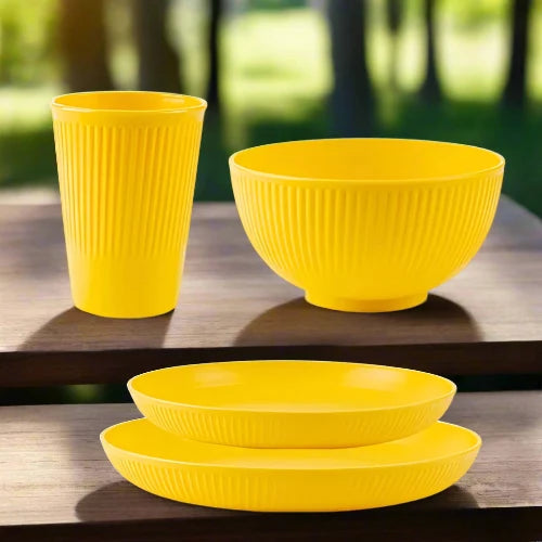 A yellow wheat straw dinnerware set. The set includes one large plate, one small plate, one bowl and one cup.