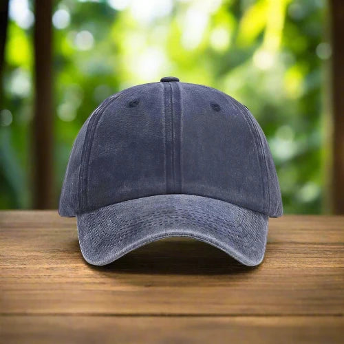 A navy stone washed baseball cap in natures scenery.