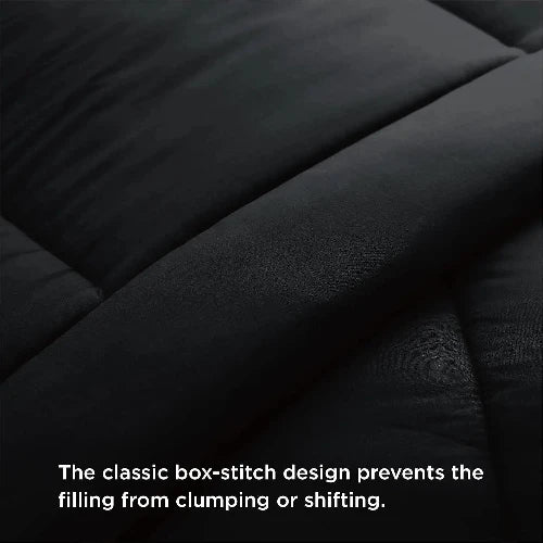 A cozy black duvet insert with the top folded down and text that says, "The classic box-stitch design prevents the filling from clumping or shifting."