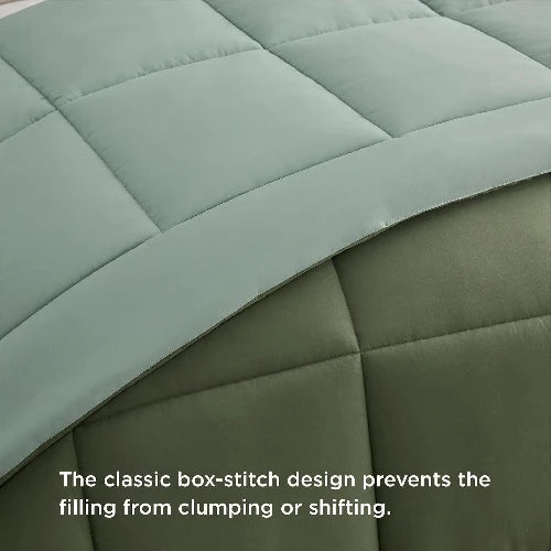 A cozy light grey and army green reversable duvet insert/comforter with the top folded down and text that says, "The classic box-stitch design prevents the filling from clumping or shifting."