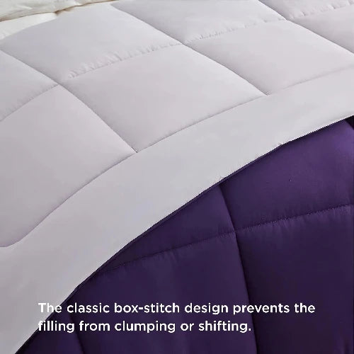 A cozy white and blue reversable duvet insert/comforter with the top folded down and text that says, "The classic box-stitch design prevents the filling from clumping or shifting."