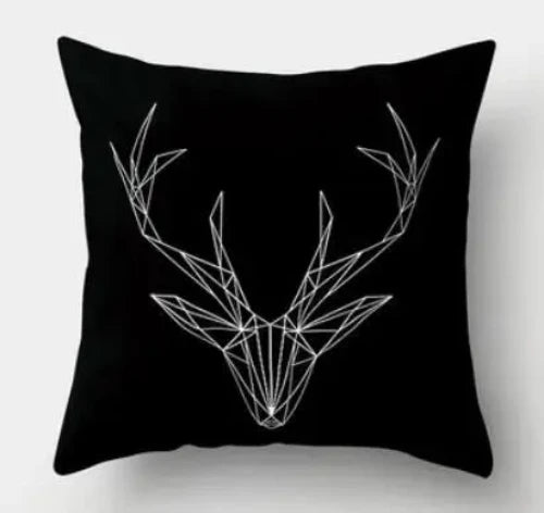 A black throw pillow with a white line drawing of a geometric deer with antlers.