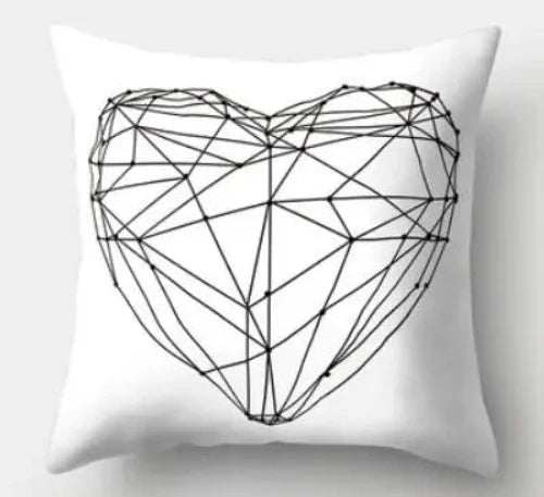 A white throw pillow with a black line drawing of a geometric heart in the center.