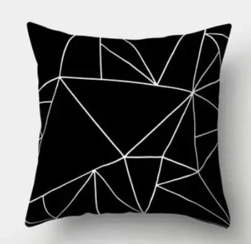 A black square throw pillow with white lines creating a geometric design.