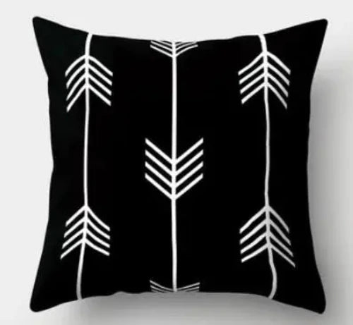 A black square throw pillow with three rows of arrows. The outer two rows are pointing up and the middle row is pointing down.