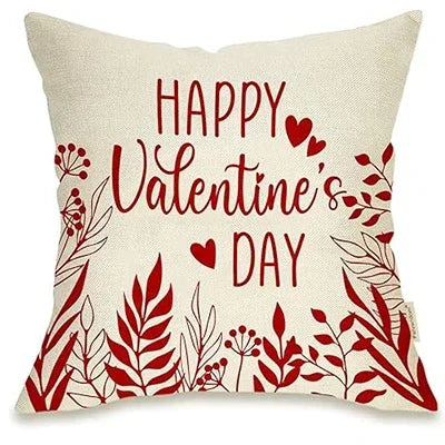 White pillow cover, says "Happy Valentine's Day" in red decorative font.  Several hearts placed throughout.  Leaves and flowers in red placed throughout bottom and sides of sham.