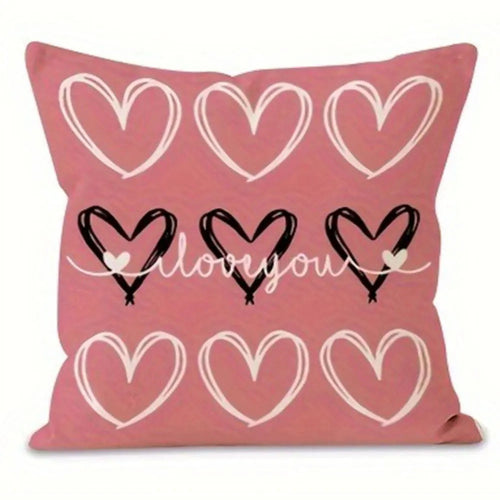 Pink pillow cover with three hearts on top and three hearts on bottom.  Three black hearts in middle and cursive love you in middle 