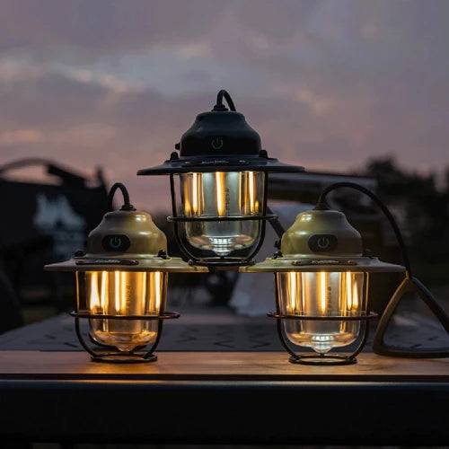 This picture is shown with three color option lamps on a metal table at a campsite