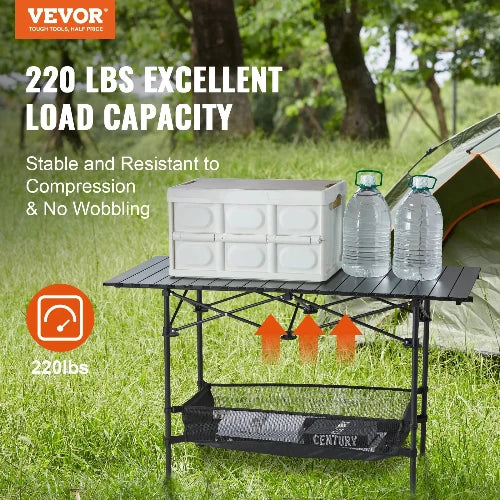 This picture is taken on a campsite in front of a tent. The VEVOR Logo is featured in the top left-hand corner. Just below the Logo is a header, "220 Lbs. Excellent Load Capacity" and sub-heading "Stable and Resistant to Compression & No Wobbling" Below the sub-header is a bullet point "220 lbs." On top of the table is the storage container and 2 jugs of water.  There are arrows ponging out the expandable feature. There is a net basket attached at base wit several books inside.