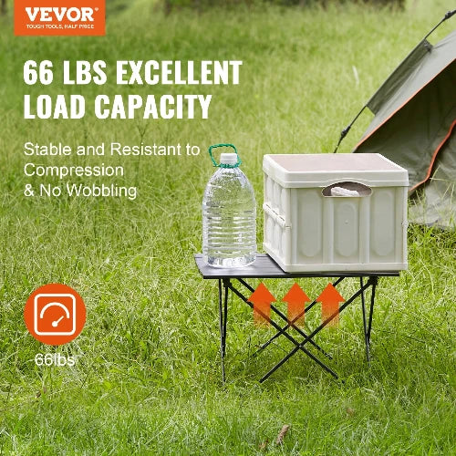 This picture is taken at a campsite in front of a tent.  The VEVOR Logo is placed at the top left-hand side. The header says "66 Lbs. Excellent Load Capacity" and sub-header says "Stable and Resistant to Compression & Wobbling" To the bottom left-hand side it shows the "66 lbs. capacity" There are arrows pointing up to show the adjustable feature of this table.  ON top of the table is the storage container and water jug.