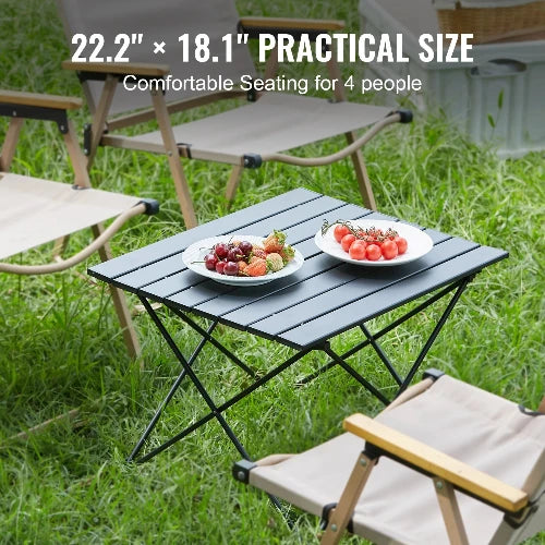 This picture is taken at a campsite around folding chairs. The heading says, "22.2" x 18.1" Practical Size" sub-heading says, "Comfortable Seating for 4 People". Two plates of fruit are on the table. 