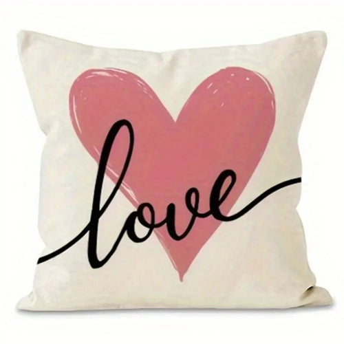 White pillow cover with a pink heart in the middle.  Love written in cursive