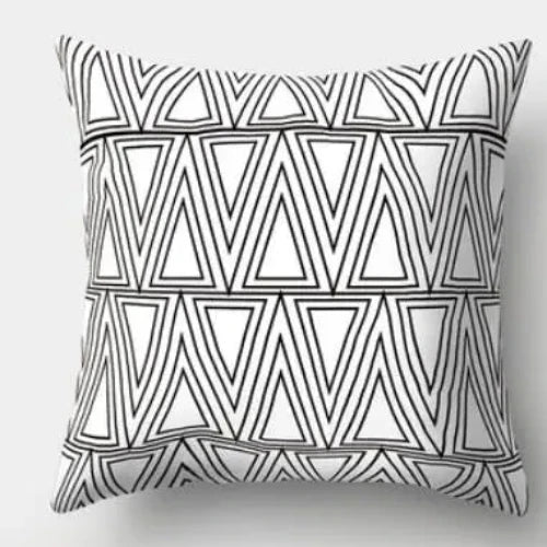 A white square throw pillow with a repeating pattern of black triangles creating a geometric design.