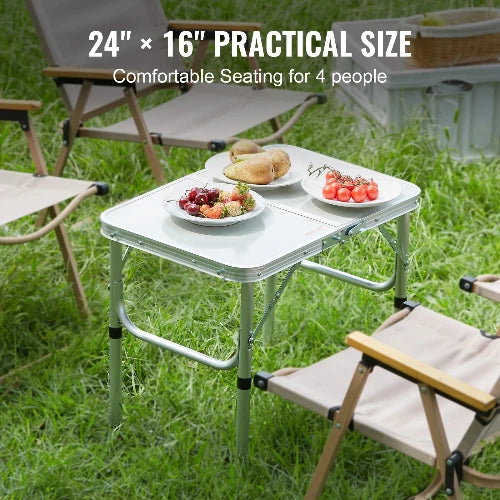 This picture shows several folding chairs surrounding the folding table at a campsite.  The header says 24in x 16in Practical Size and a sub header that says Comfortable Seating for 4 people.